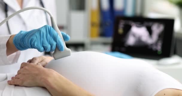La donna incinta viene sottoposta ad ultrasuoni in primo piano in clinica. Esame del feto del concetto di bambino - Filmati, video
