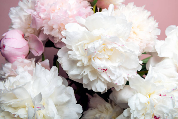 Abundance of Fresh bunch of Peonies Bouquet of different pink colors on pink background. Card Concept, copy space for text - Photo, Image