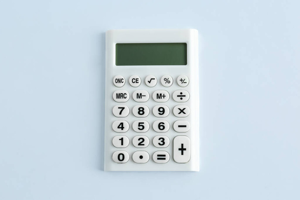 Modern calculator on white background, top view - Valokuva, kuva