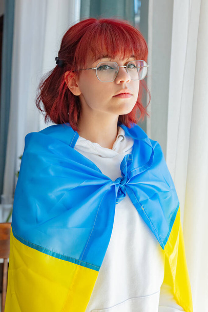 młody ruda ukraiński nastolatek dziewczyna z flaga w pobliżu okna - Zdjęcie, obraz