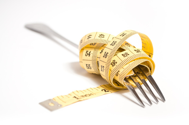 Measuring tape on a fork concept - Foto, afbeelding