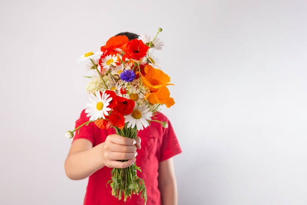 Boy holding Wild Flower bouquet for Mother Day. simple blooming summer lifestyle - Φωτογραφία, εικόνα