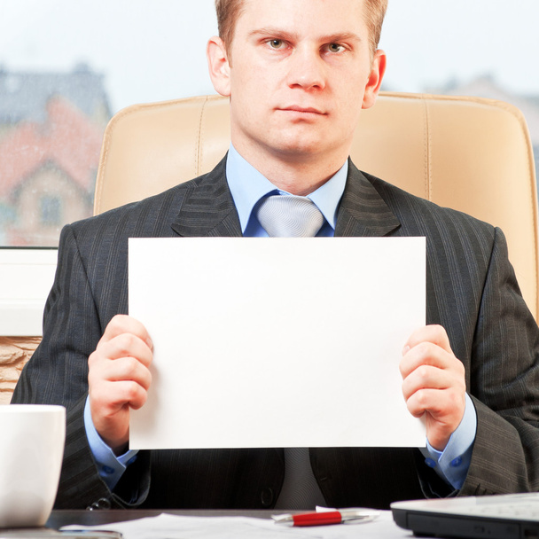 Young businessman holding blank paper - Photo, Image