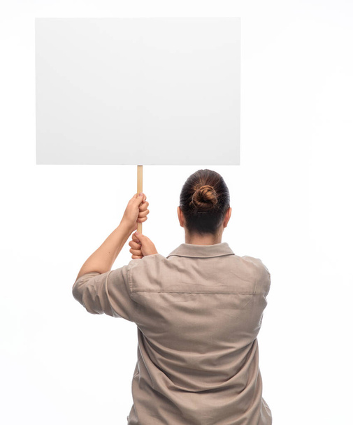 feminism and human rights concept - woman with poster protesting on demonstration over white background - Foto, Imagen