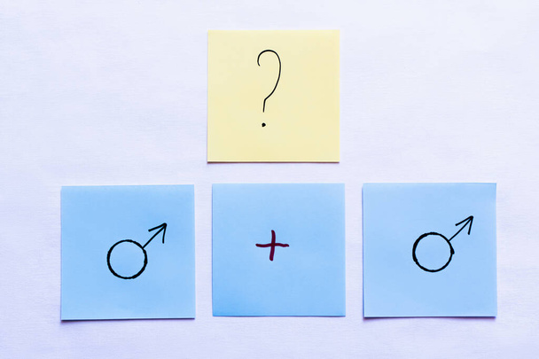 top view of cards with question mark and plus sign near male symbols on white background - Foto, imagen