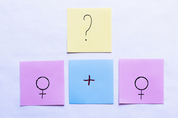top view of papers with plus sign and question mark near female symbols on white background - Photo, Image