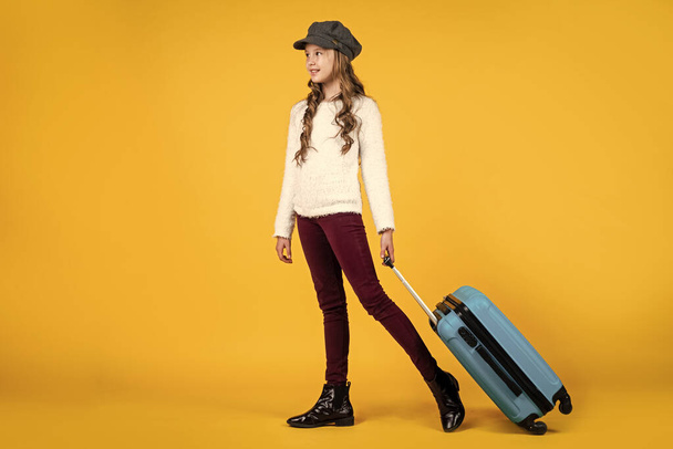 happy kid in cap with travel bag suitcase, traveling. - Φωτογραφία, εικόνα