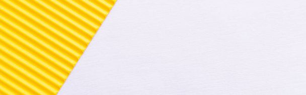 top view of bright yellow textured paper on white background, banner - Foto, Bild