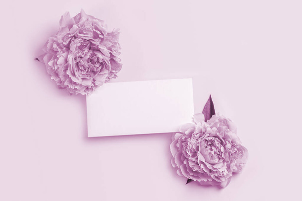 Invitation or greeting card mockup with delicate pink peonies frame and empty blank. - Valokuva, kuva