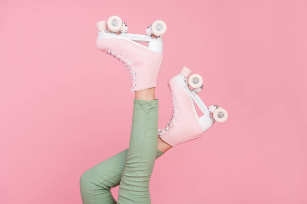 Cropped photo of slim legs wear pants roller skates sport hobby isolated over pastel color background. - Fotó, kép