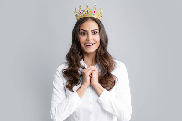 Portrait of woman queen. Gorgeous girl with crown. Party celebration concept. Close-up portrait of charming smiling lovely girl holding queen crown, gray background - Photo, Image