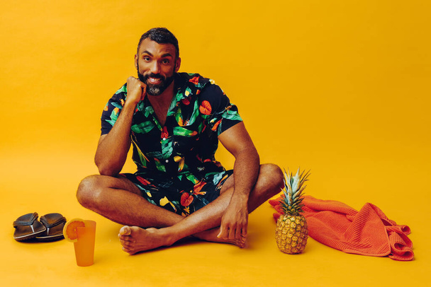 handsome african american man on vacation sitting on the floor  - Zdjęcie, obraz