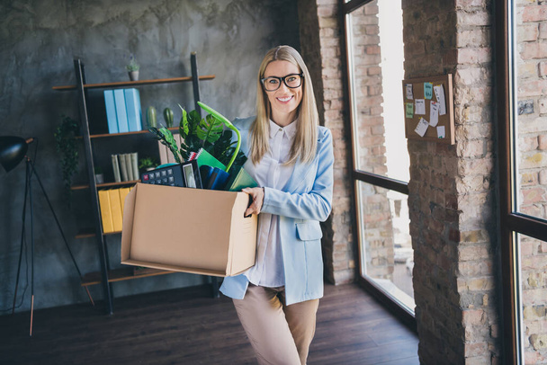 Photo of optimistic representative accountant have first day new work ready meet colleagues hold package in workspace loft. - Foto, Imagen