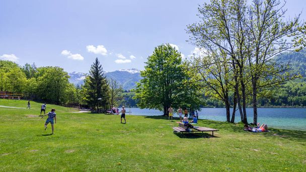 Bohinj, Slovenia - April 29, 2018: Lake Bohinj in Slovenia. Colorful summer on the Bohinj lake in Triglav national park Slovenia, Alps, Europe. Mountain Lake bohinj in Julian Alps, Slovenia - Photo, Image