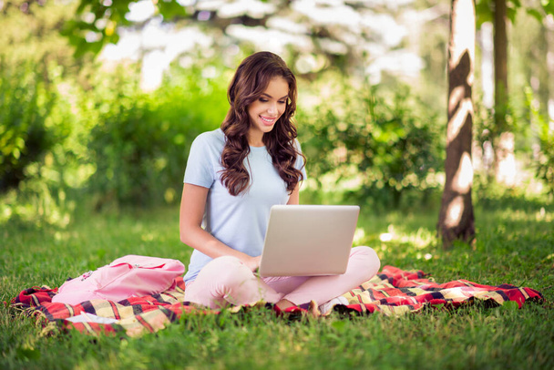 Full length body size photo female programmer working remotely sitting with laptop in city park. - Φωτογραφία, εικόνα