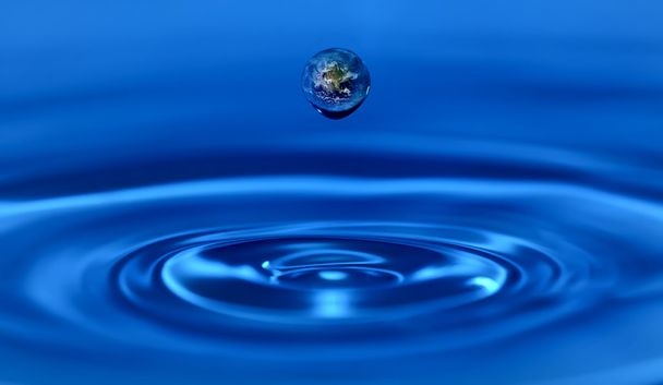 Earth within a water drop. - Photo, Image
