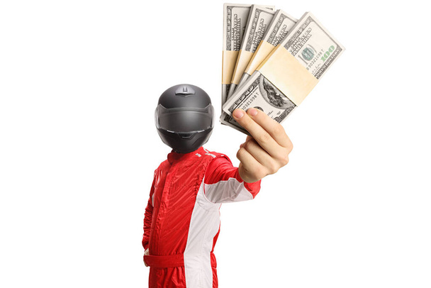 Racer with a helmet holding stacks of money isolated on white background - 写真・画像