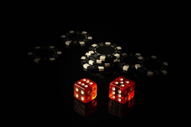Craps is a dice game in which players bet on the outcomes of a pair of dice. Black chips received as a result of winning - Photo, Image