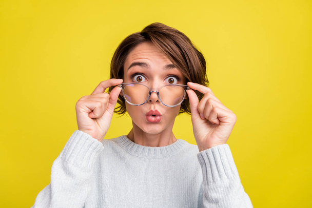 Photo of crazy surprised funny lady open mouth omg face wear glasses blue pullover isolated yellow color background. - Photo, image