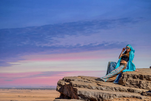 A gorgeous model poses outdoors in the mountains of Morocco - Photo, Image