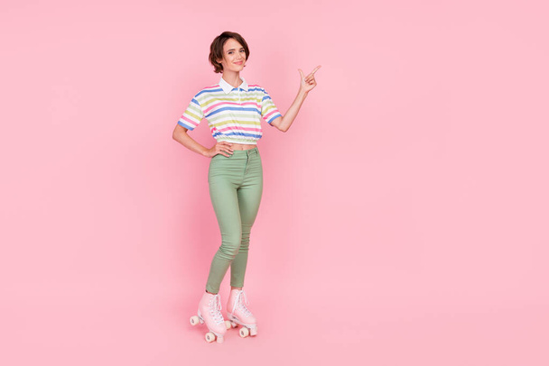 Full body photo of young girl happy smile roller skater point finger empty space ad choice isolated over pink color background. - Φωτογραφία, εικόνα