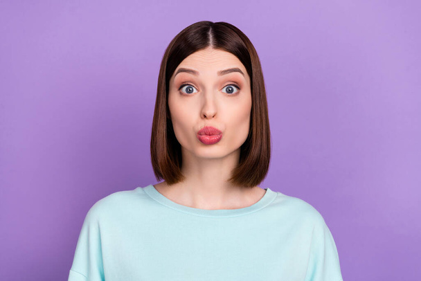 Photo portrait girl wearing blue pullover sending air kiss isolated pastel violet color background. - Foto, Imagen