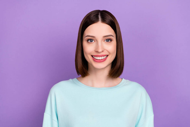 Photo portrait smiling girl wearing blue sweatshirt isolated pastel violet color background. - Foto, afbeelding
