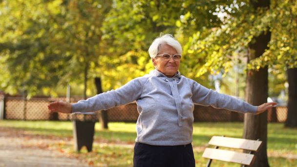 middle aged Caucasian woman works out in park medium shot copy space . High quality photo - Photo, Image
