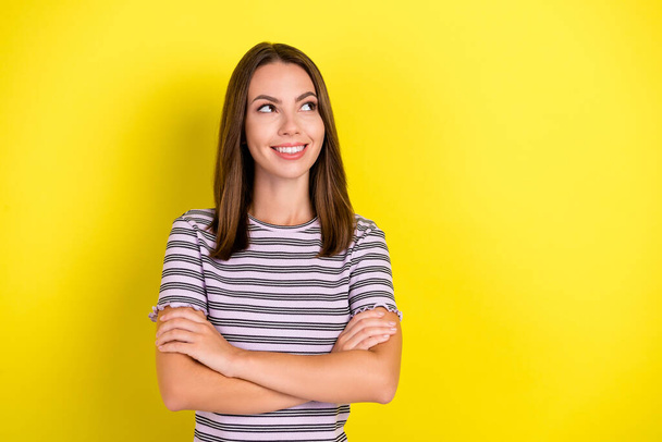 Photo of cool millennial brunette lady crossed arms look empty space wear striped t-shirt isolated on yellow background. - Foto, immagini