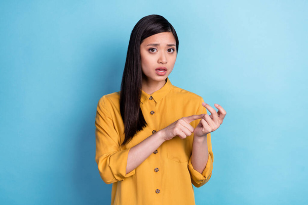 Photo of nice young brunette lady count wear yellow shirt isolated on blue color background. - 写真・画像