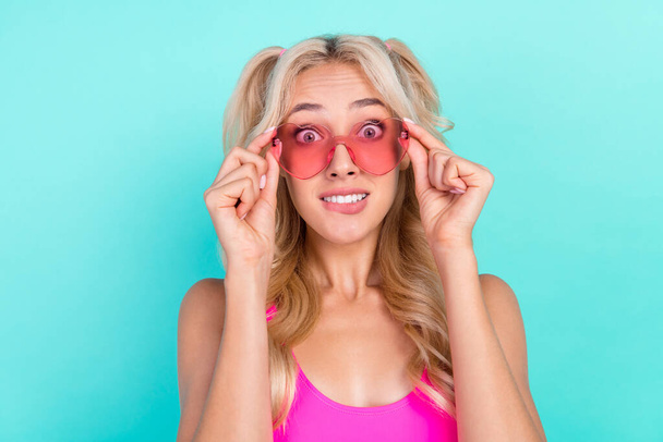 Photo of young girl hands touch glasses amazed shocked stupor omg isolated over turquoise color background. - Foto, Imagem