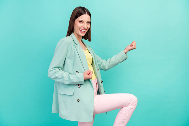 Profile photo of hooray millennial brunette lady hands fists wear jacket isolated on cyan color background. - 写真・画像