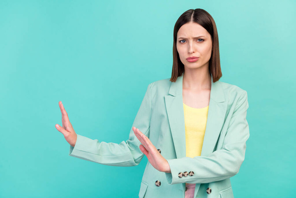 Photo of sad young brunette lady stop gesture wear jacket isolated on cyan color background. - Foto, afbeelding
