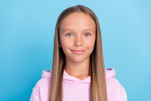 Photo of positive happy young little girl wear sweatshirt casual smile enjoy isolated on blue color background. - Valokuva, kuva
