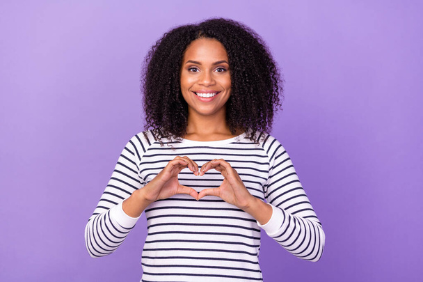Photo of young smiling good mood woman showing heart symbol adore admire romance isolated on purple color background. - Foto, imagen