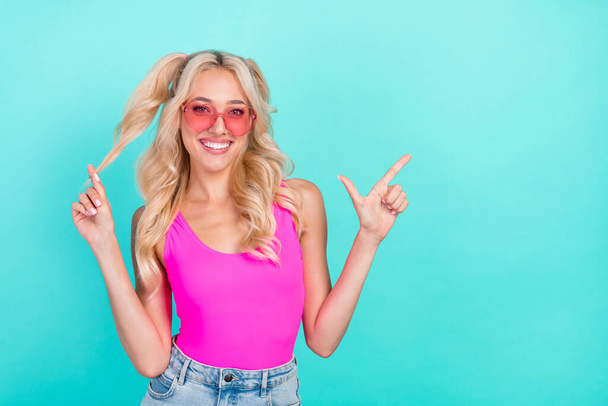 Photo of young girl happy positive smile point finger empty space ad promo direct suggest isolated over turquoise color background. - Фото, зображення