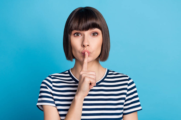 Photo of young silent mute woman hold finger face lips tell secret gossip isolated on pastel blue color background. - Foto, Imagem
