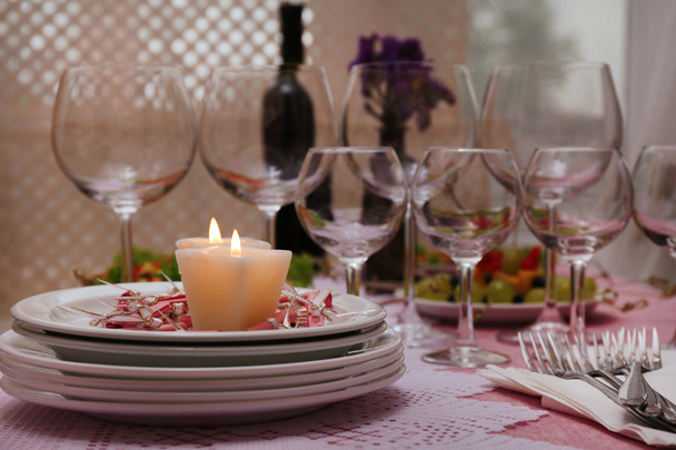 Buffet table with dishware and candles waiting for guests - Photo, image