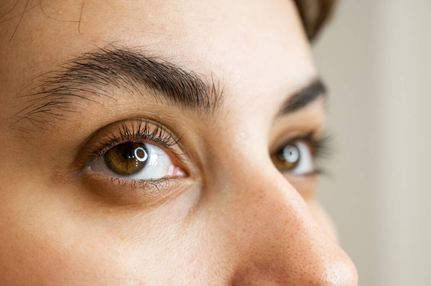 Close-up portrait of a young caucasian woman before eyelash lamination procedure - Foto, imagen