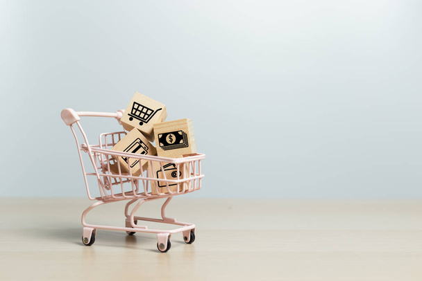 Online shopping concept. Wooden cubes block with business icons in shopping cart, sell marketing purchase delivery. - Photo, Image