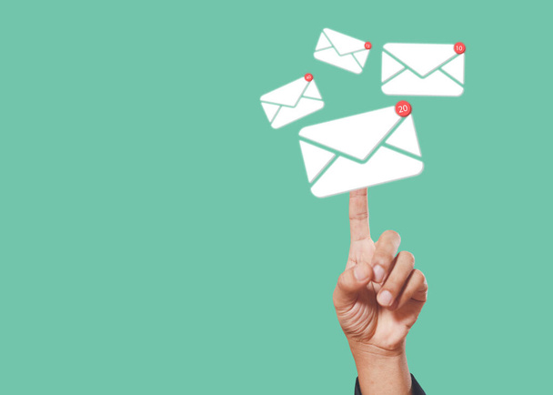 Sending email contact network concept. Hands finger touch pointing email contact icons green background, communication message send and receive. - Photo, Image