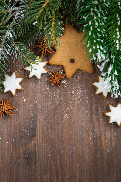 Wooden background with fir branches and cookies, top view - Fotografie, Obrázek