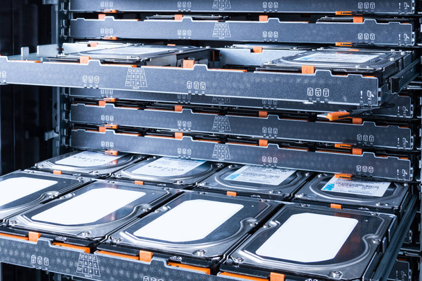 Cluster of hard drives inside open tray - a cloud data storage concept - Photo, Image