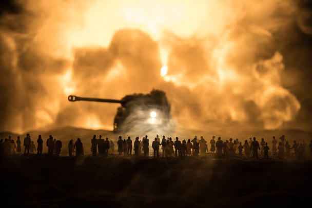 Creative artwork decoration - Russian war in Ukraine concept. Crowd looking on giant explosion and attacking armored vehicles. Selective focus - Photo, Image