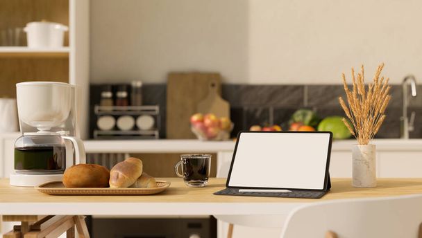 Una maqueta portátil de la pantalla blanca de la tableta, cafetera, panes en cesta y una taza de café negro en la mesa de comedor de madera sobre borrosa cocina casera mínima en el fondo. representación 3d, ilustración 3d - Foto, Imagen