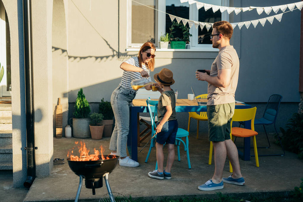 happy caucasian family having barbecue party in home backyard - Fotografie, Obrázek