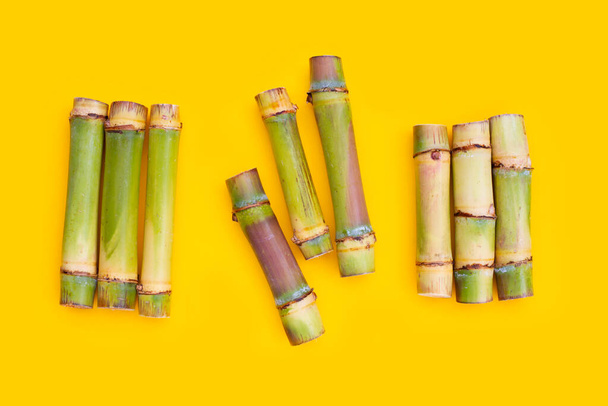 Sugar cane on yellow background. - Fotografie, Obrázek