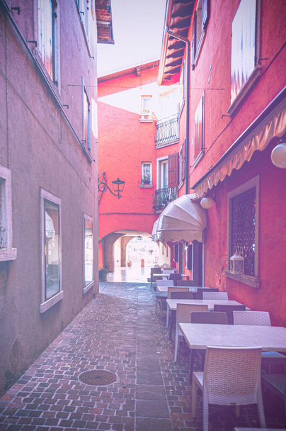 Leere Straßencafés in Italien während der Quarantäne in verblasster Farbe.  - Foto, Bild