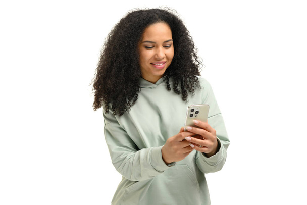 Attractive young multiracial woman web browsing on smartphone, millennial female chatting on social networks, using mobile app, texting online with friends, sharing news, isolated on white - Φωτογραφία, εικόνα