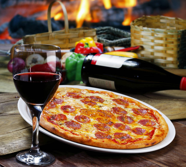 Pepperoni pizza with red wine - 写真・画像